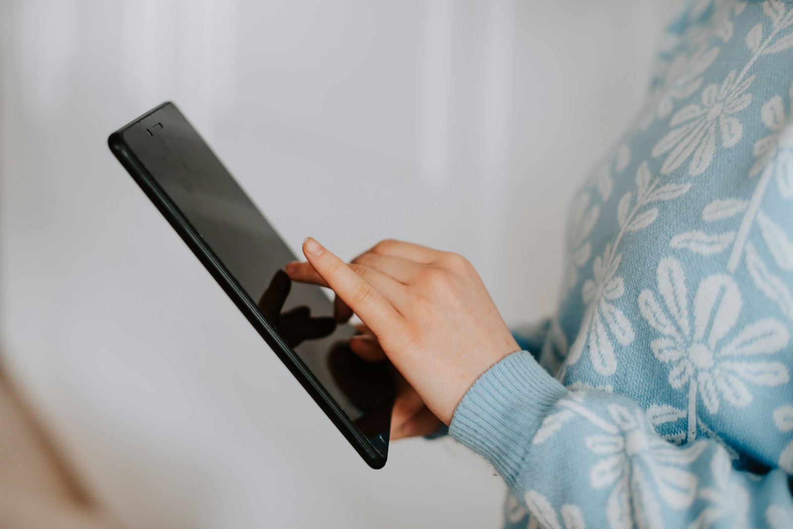 a close up of a person holding a tablet